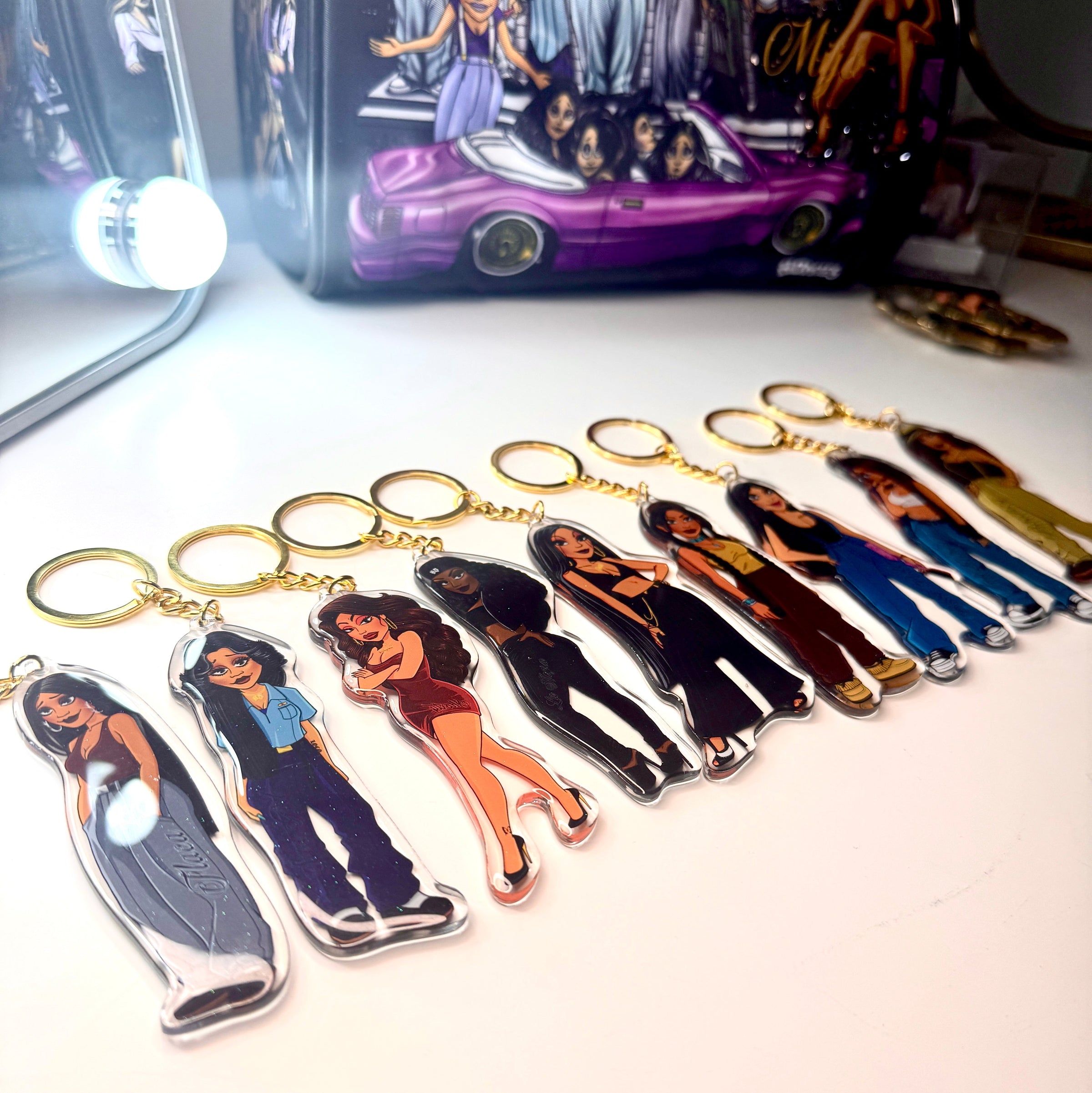 Bundle of HomieGirl New School keychains featuring modern Chicana characters with bold street-style designs and collectible flair