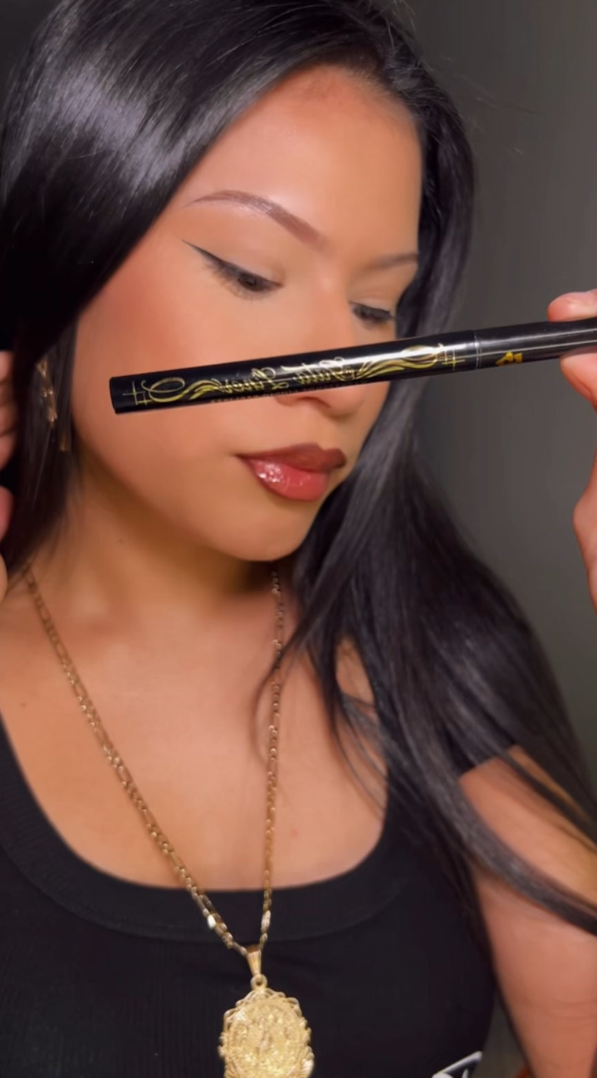 Model wearing HomieGirl Gata Eyeliner – sharp winged liner with bold definition